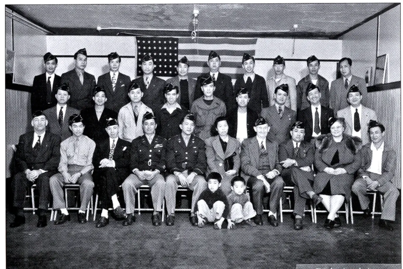 Enlarged archival group photograph of Chinatown Post 628 veterans and their families.